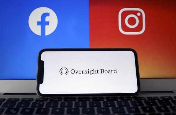 The Oversight Board logo on a phone screen against backdrop of Facebook/Instagram logos